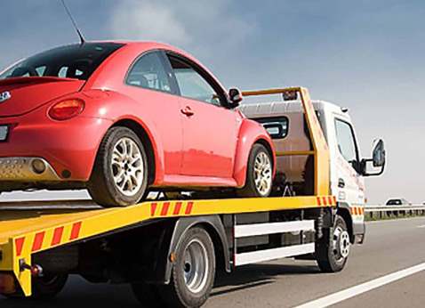 A volkswagen being towed by our tow truck service after breaking down on the highway